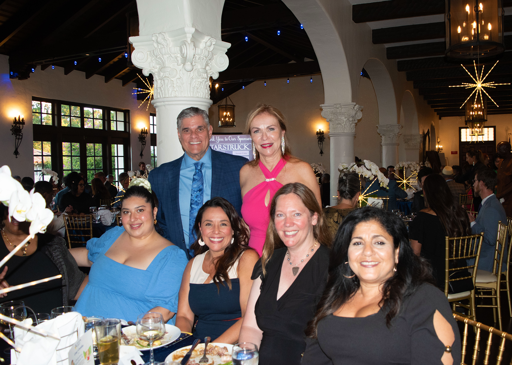 Rose and Gordon Smiling with members of the San leandro chamber of commerce at the annual gala